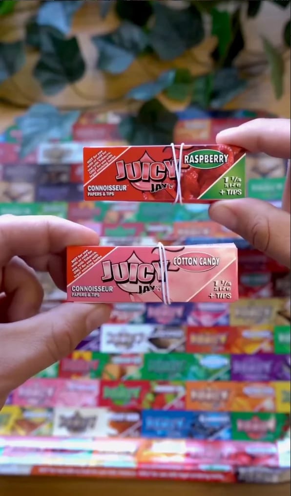 Juicy Jay's Connoisseur papers in Raspberry and Cotton Candy held up in two hands