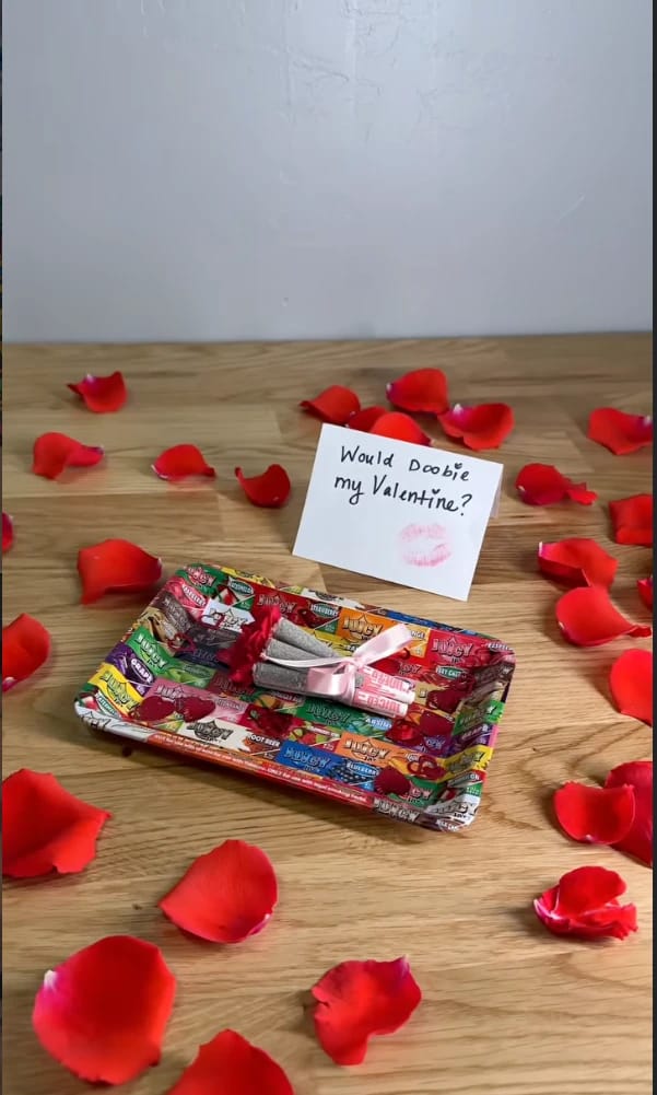 Juicy Jay's rolling tray with rose petals and a "Would Doobie my Valentine?" card